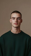 Fototapeta premium Modern minimalist portrait of a young man with a confident expression against a neutral background