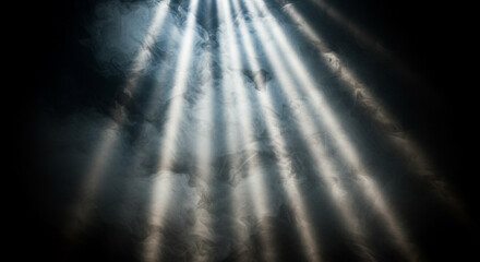 Bright light shines through smoke on black background. Ethereal mist creates magical glow. God&rsquo;s rays beam down in surreal fantasy stage lighting atmosphere