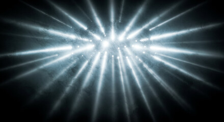 Obraz premium Bright light shines through smoke on black background. Ethereal mist creates magical glow. God’s rays beam down in surreal fantasy stage lighting atmosphere