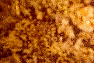 Abstract circular bokeh background of light. Shiny golden light sparkle texture