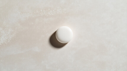 Photo of a Single Round White Tablet Placed on a Light Surface