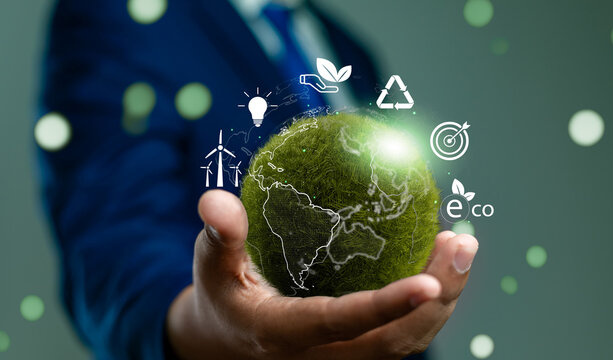 World environment day, Responsibility for a green planet, Sustainable growth, and global conservation.Businessman holding green world, Sustainable development goals and corporate social responsibility