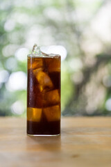 Iced american coffee in tall glass on wood table