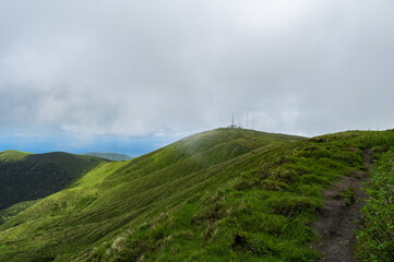 Crater of Vulcão da Caldeira or The Caldeira Volcano on Faial Island, the Azores, in the Atlantic Ocean. Stratovolcano with a lake inside the crater. Low clouds. Hiking around volcano.