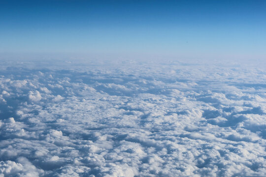 White cumulus fluffy clouds wallpaper taken from the plane in a blue sky good weather day