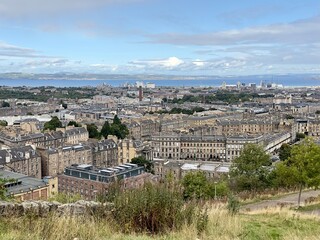 A high angle view of the urban sprawl of Edinburgh looking towards to coastline and the First of Forth. 