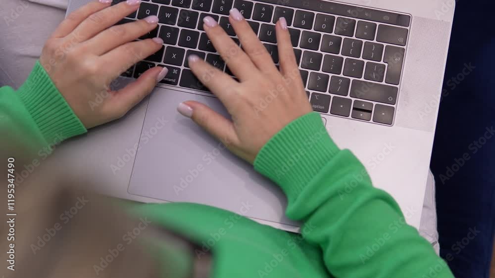 Poster close-up of hands typing on a laptop keyboard in a modern workspace. focus on productivity and remot