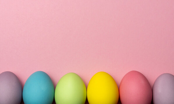 Colorful easter eggs on pink background with copy space for text - Powered by Adobe