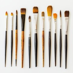Fototapeta premium Collection of various paintbrushes arranged in a straight line on a light background