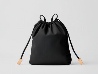 A stylish black drawstring bag with a textured finish, featuring two cords for closure and a minimalist design. product presentation mockup.