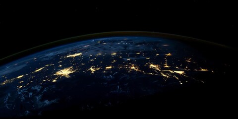 Obraz premium A view of Earth from space, showcasing illuminated cities and natural features at night.