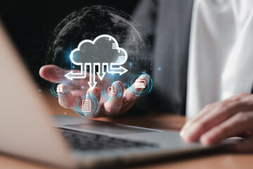 Business person migrate data and corporate information into cloud technology for data security and...