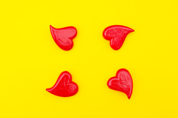 Red hearts on a yellow background. View above. Valentines day card