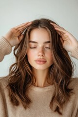 Naklejka premium Young caucasian female with brown hair relaxing and meditating with closed eyes