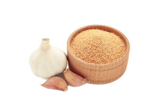 Fresh garlic and garlic powder in bowl isolated on white background. Using spices for meals. Top view