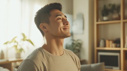 Young Kazakh man enjoys a peaceful morning in a cozy living room filled with modern decor and personal touches