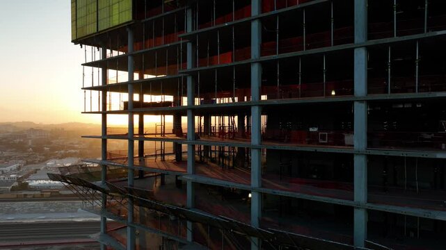 Aerial shot of a new high-rise building under construction at sunrise