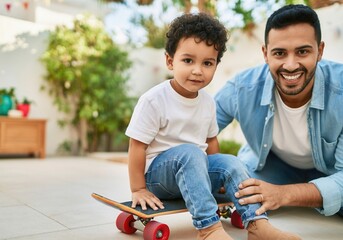 Happy father assisting his young son learning to ride a skateboard on a sunny day
