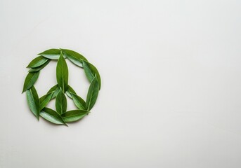 Obraz premium Green leaves arranged in peace symbol promoting environmentalism and peaceful coexistence