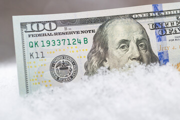 US 100 dollar banknote on the snow
