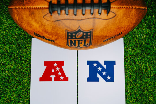 AFC vs NFC. Super Bowl Confrontation in NFL. Final match of National Football League in USA. Logo of NFC and AFC on Green Grass near football ball. File photo