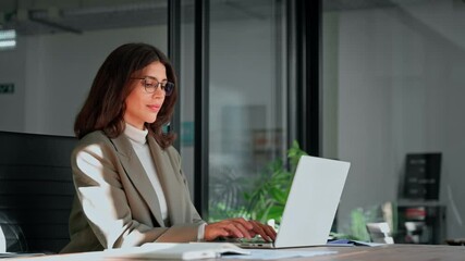 Middle age European business woman CEO using laptop application for work at table workspace in office. Smiling Latin Hispanic mature adult professional businesswoman using pc digital computer. Banner - Powered by Adobe