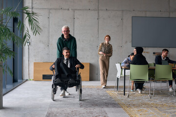 A diverse team of business colleagues, including a director in a wheelchair, engages in a...