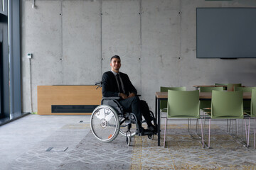 A director in a wheelchair sitting alone in an empty office, deeply reflecting on business...
