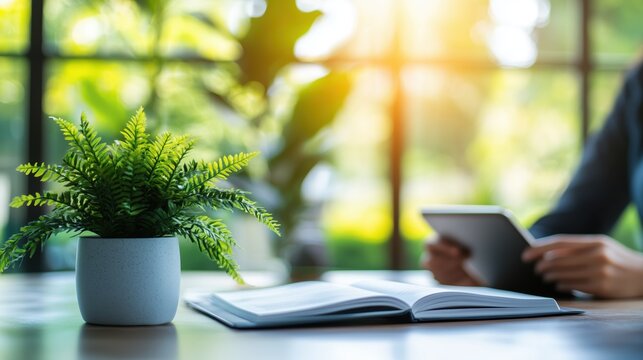 Relaxing afternoon with a tablet and a book in a serene indoor garden setting