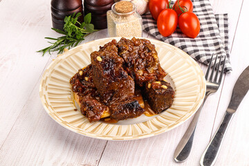 Prepared tasty beef ribs with sauce