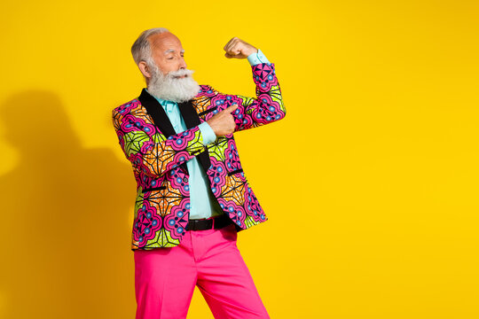 Photo portrait of attractive retired man point look flexing muscles dressed colorful pink fancy clothes isolated on yellow color background