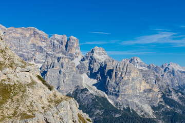 Dolomites rocky summits in the Alps. High tower peaks and sharp mountain rocky peaks of the Alps in the Dolomiti region, Italy. Beautiful scenic mountain range landscape in summer