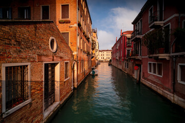Scenic canal with old architecture in Venice, Italy.
Boats and beautiful ancient and colorful buildings.
