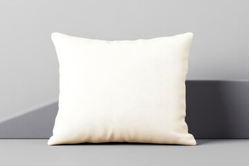 A stylish white cushion rests on a textured gray surface, offering a modern aesthetic for home decor.