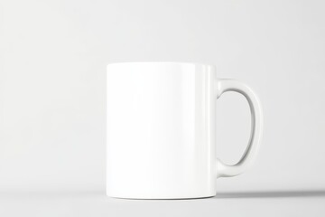 Obraz premium A simple, white ceramic mug positioned against a light background, perfect for customizable designs or branding.