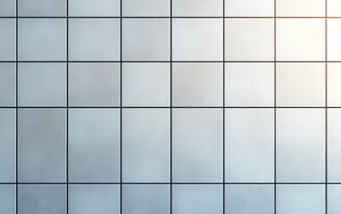 Modern glass wall with a grid pattern reflecting light and shadows in an urban setting.