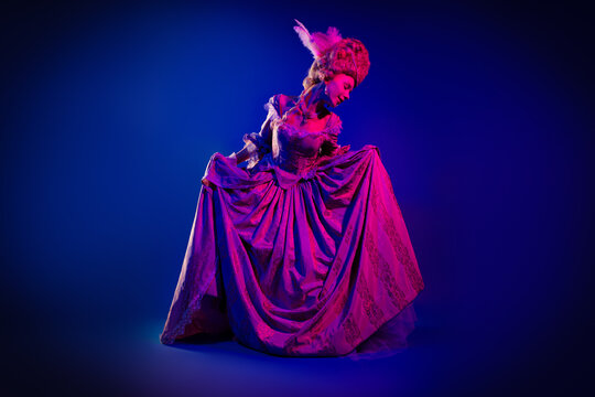 Full length photo of charming positive marie antoinette wear rich dress doing curtsy empty space isolated blue color background