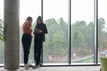 Two colleagues are having a productive conversation while looking at a tablet.