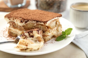 Piece of tasty tiramisu on table, closeup