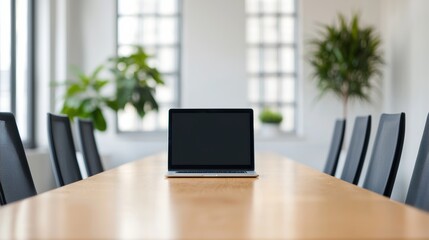 Fototapeta premium Laptop showing blank screen sitting on meeting table in modern office