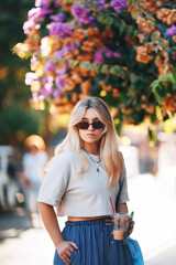 blonde girl in blue pants walking on the street in istanbul. tourist on princes islands in turkey