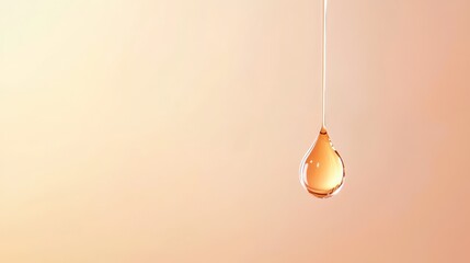 Thick, glistening, golden drop is suspended in mid air, captured just before impacting a softly illuminated orange surface, creating a sense of anticipation and delicate beauty