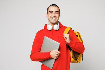Young IT middle eastern man boy student wear red casual clothes backpack bag hold books work closed...