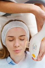 Facial acne and pigmentation laser therapy. Care of scarred acne skin by beautician. Laser skin...