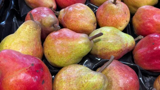 Williams pears on display at the greengrocer's, tracking shot on pears in crates