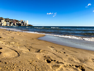 Relax on Levante Beach, Benidorm (Spain). The golden sand of the White Coast. Enjoy the sun, the sea and the vibrant atmosphere of this emblematic White Coast beach in Benidorm.