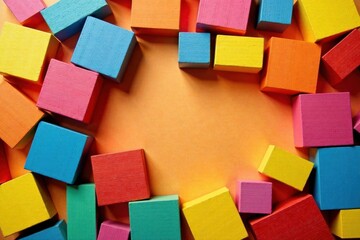 A vibrant collection of colorful wooden blocks arranged in a circular frame against a warm orange background, creating a playful and engaging composition.