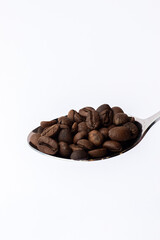 Freshly roasted coffee beans, scattered elegantly on a clean white background.