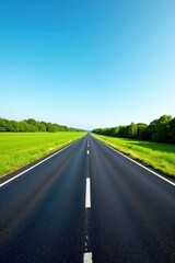 Asphalt Road Stretching Towards a Vibrant Horizon Under a Clear Blue Sky