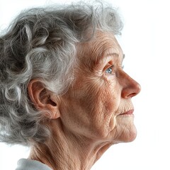 Side profile portrait of an elderly woman with curly gray hair and expressive blue eyes, showing natural wrinkles against a clean white background